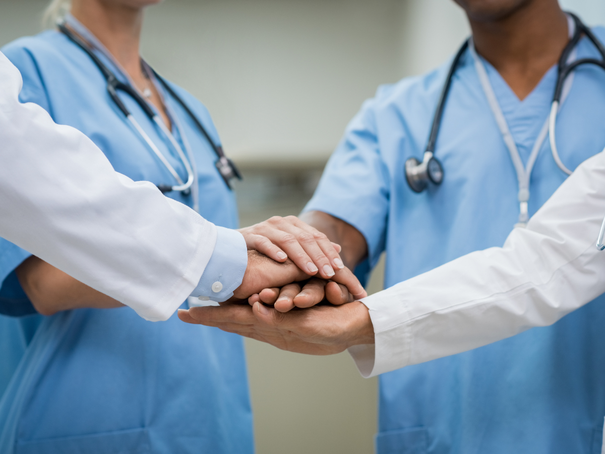 Medical professionals' hands together